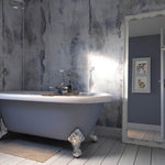 Elegant freestanding bathtub with clawfoot design in a stylish bathroom with distressed wall finish, wooden flooring, and animal artwork