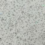 Terrazzo flooring pattern with gray background and varying shapes and sizes of stone chips