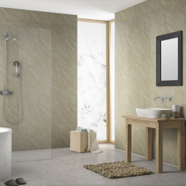 Modern bathroom interior with walk-in shower, transparent glass panel, beige stone tiles, wooden washstand with vessel sink, wall-mounted faucet, framed mirror, and decorative plant near frosted window.