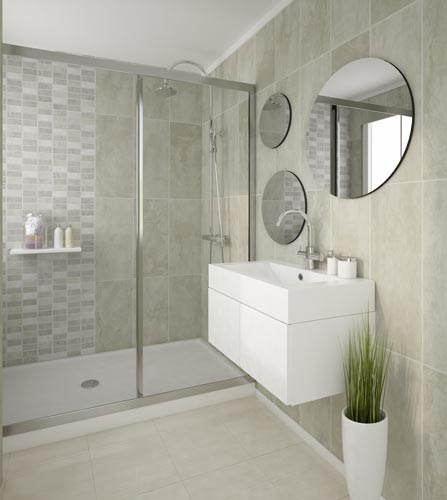 Modern bathroom interior with glass shower cubicle, beige tiles, white vanity cabinet, round mirror, and decorative plant