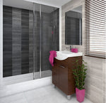 Modern bathroom interior with glass shower cabin, wooden vanity cabinet, white basin, large mirror, pink accents, and indoor plant