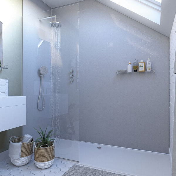 Modern bathroom with walk-in shower, skylight, hexagonal tile flooring, glass shower door, white vanity, wall-mounted showerhead, handheld sprayer, and green potted plants in woven baskets.