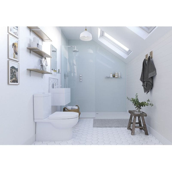 Modern bathroom interior with white walls, walk-in shower, skylight, floating shelves, wall art, white toilet, pendant light, herringbone tile floor, wooden stool, and green plant accents.