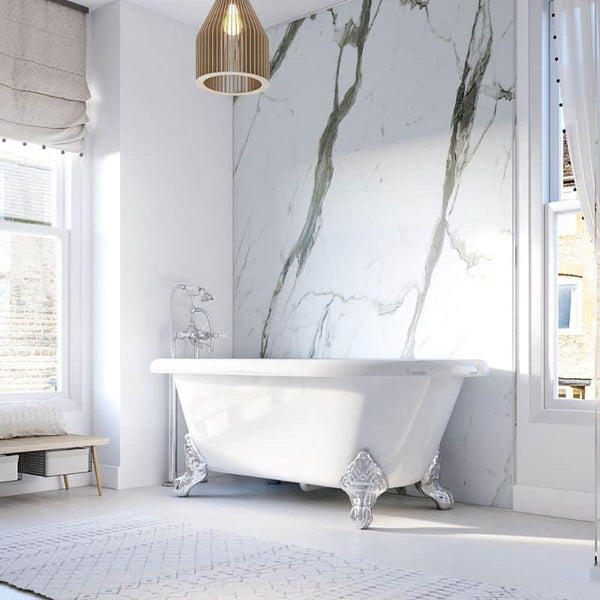 Luxurious modern bathroom interior with freestanding white bathtub, marble walls, herringbone tile floor, and elegant pendant light.