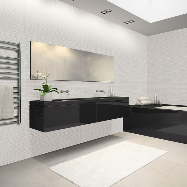 Modern bathroom interior with floating vanity, dual sinks, large mirror, white textured walls, towel warmer, and minimalist design elements