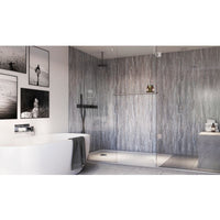 Modern bathroom interior with textured gray marble walls, frameless glass shower enclosure, rainfall shower head, freestanding white bathtub with gray towel, black fixtures, monochrome framed wall art, and recessed ceiling lighting.