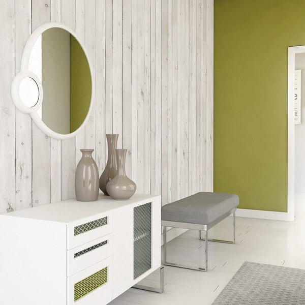 Modern minimalist entryway with white and wood panel walls, olive green accent, round mirror, white console table, grey upholstered bench, beige vases, and patterned grey rug