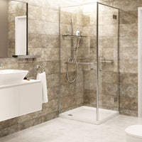 Modern bathroom interior with beige tile wall, glass shower enclosure, rainfall shower head, white vanity unit with basin, wall mirror, and fluffy towel.