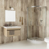 Modern bathroom interior with curved glass shower enclosure, wall-mounted vanity, beige textured tiles, and minimalist decor.