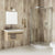 Modern bathroom interior with curved glass shower enclosure, wall-mounted vanity, beige textured tiles, and minimalist decor.