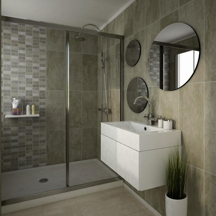Modern bathroom interior with glass shower cubicle, beige tiles, white vanity sink, round mirror, wall-mounted towel shelf, shower head, potted plant, and bath accessories.