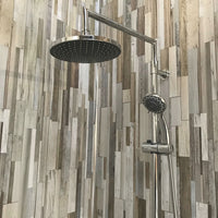 Modern bathroom shower system with rain showerhead and adjustable handheld shower spray against a backdrop of multicolored wood plank tile wall