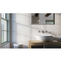 Modern minimalist bathroom interior with natural light, wall-mounted mirror, vessel sink on wooden vanity, exposed wooden beams, and industrial pendant light