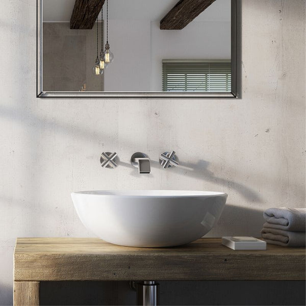 Modern bathroom interior with vessel sink on wooden vanity, wall-mounted faucet, large mirror, and pendant lights