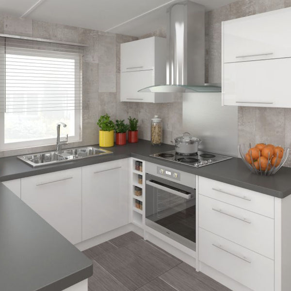 Modern kitchen interior with white cabinetry, stainless steel appliances, granite countertops, and colorful potted herbs on windowsill