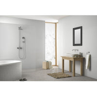 Modern bathroom interior with freestanding bathtub, walk-in shower, wood vanity, vessel sink, minimalist decor, tiled floor, and glass shower panel.