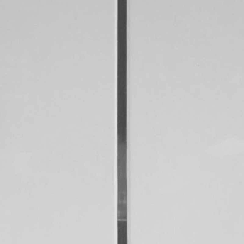 Minimalist black and white photography of a vertical line dividing the image into two equal parts, abstract background, simplicity concept, balanced composition, monochrome texture