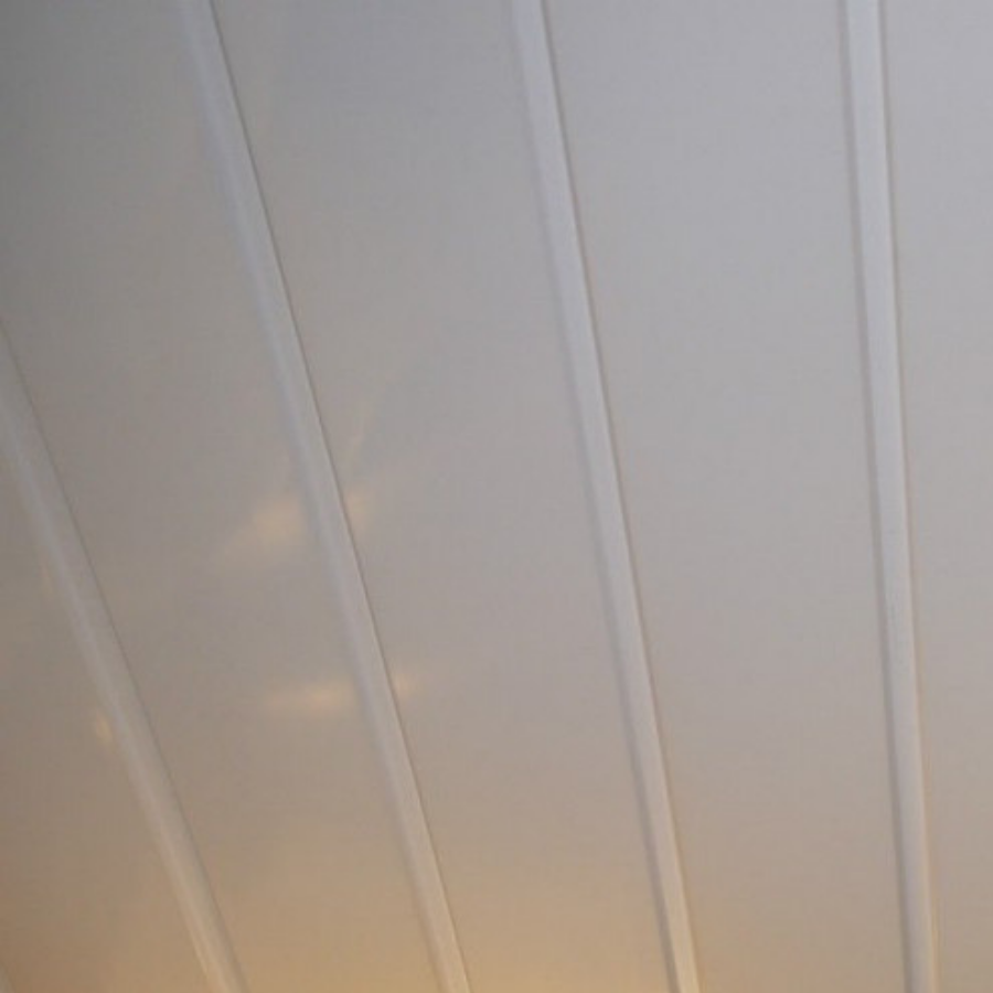 Abstract angled view of off-white vertical lines possibly representing curtains or architectural details with subtle warm light reflection in the background indicating sunrise or sunset.